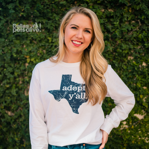 smiling female wearing Dallas Pets Alive! Adopt Y'all white long sleeve t-shirt