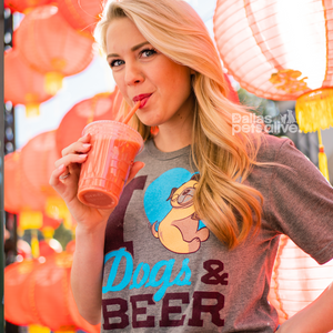 smiling female wearing grey short sleeve t-shirt illustrated with I HEART DOGS AND BEER on the front